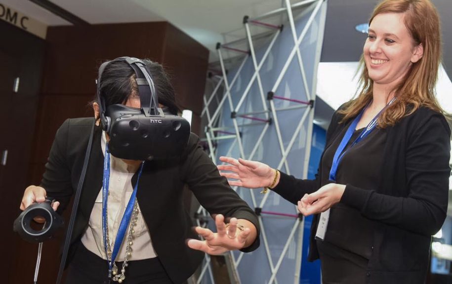 girl trying htc vive virtual reality at business leaders of michigan event detroit