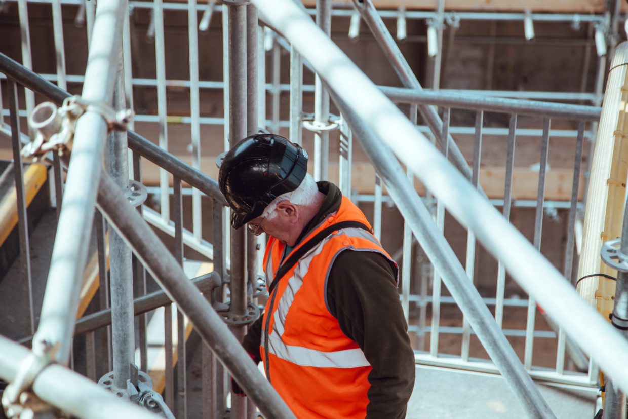 A worker in an orange vest and hard hat