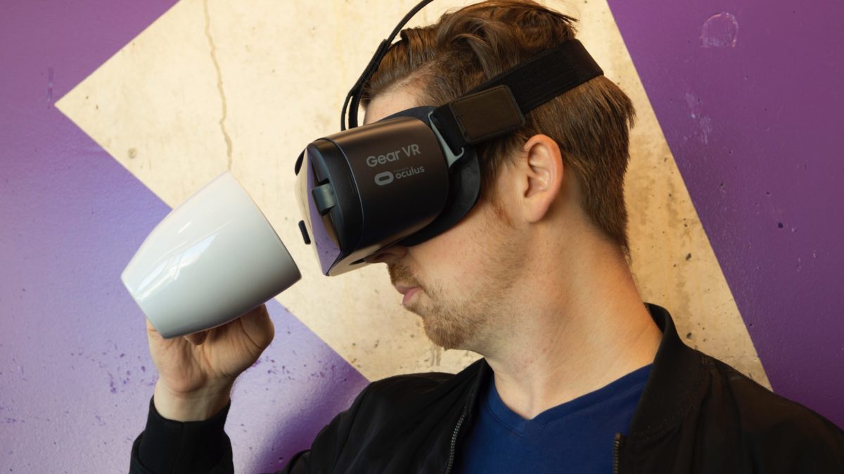 Someone in a VR headset looking into a coffee cup