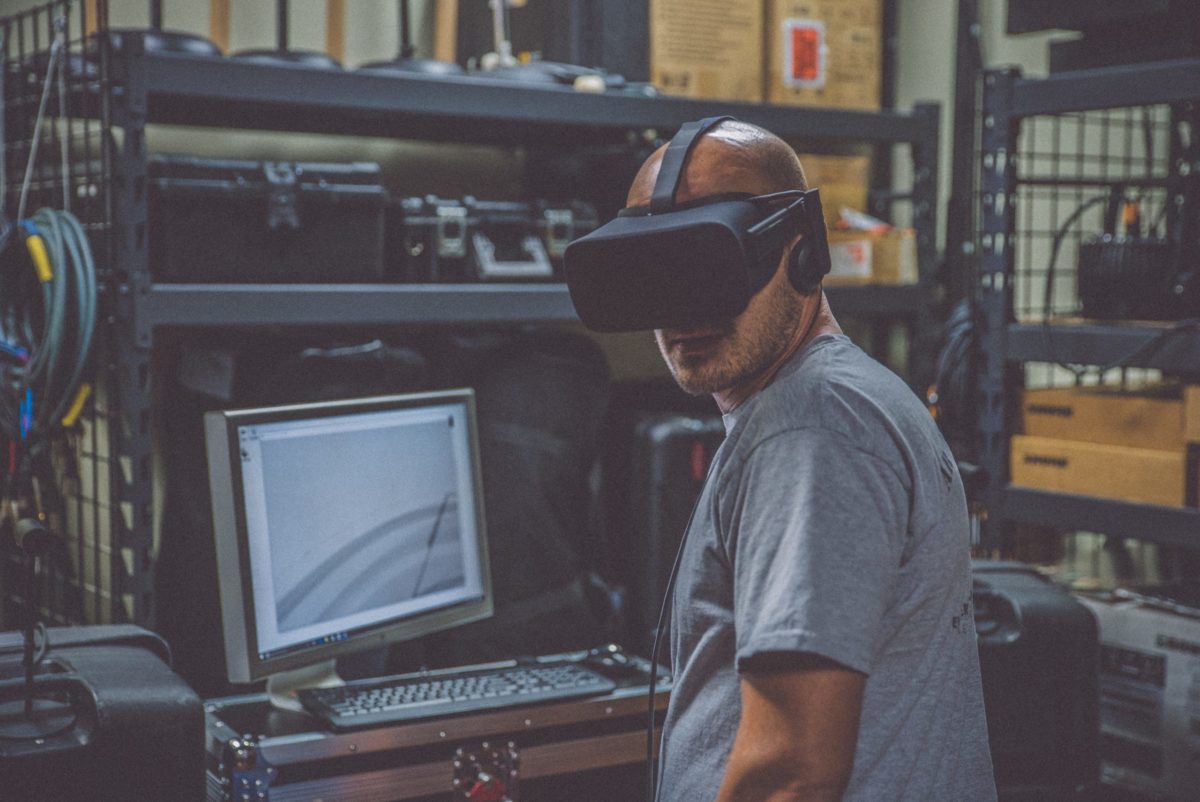 A person in a VR headset in a work space