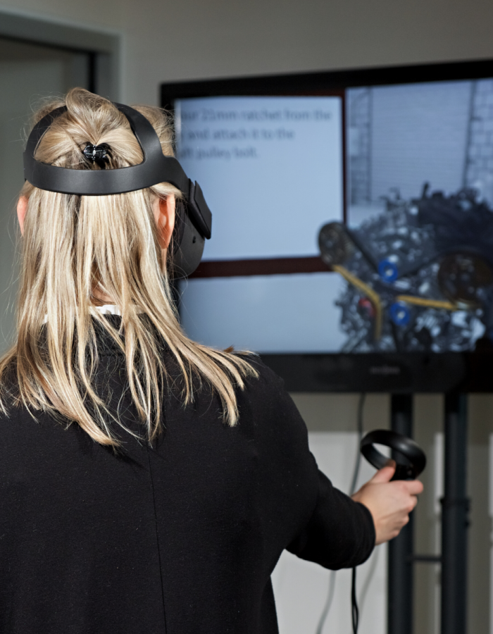 A woman using virtual reality cased to a TV