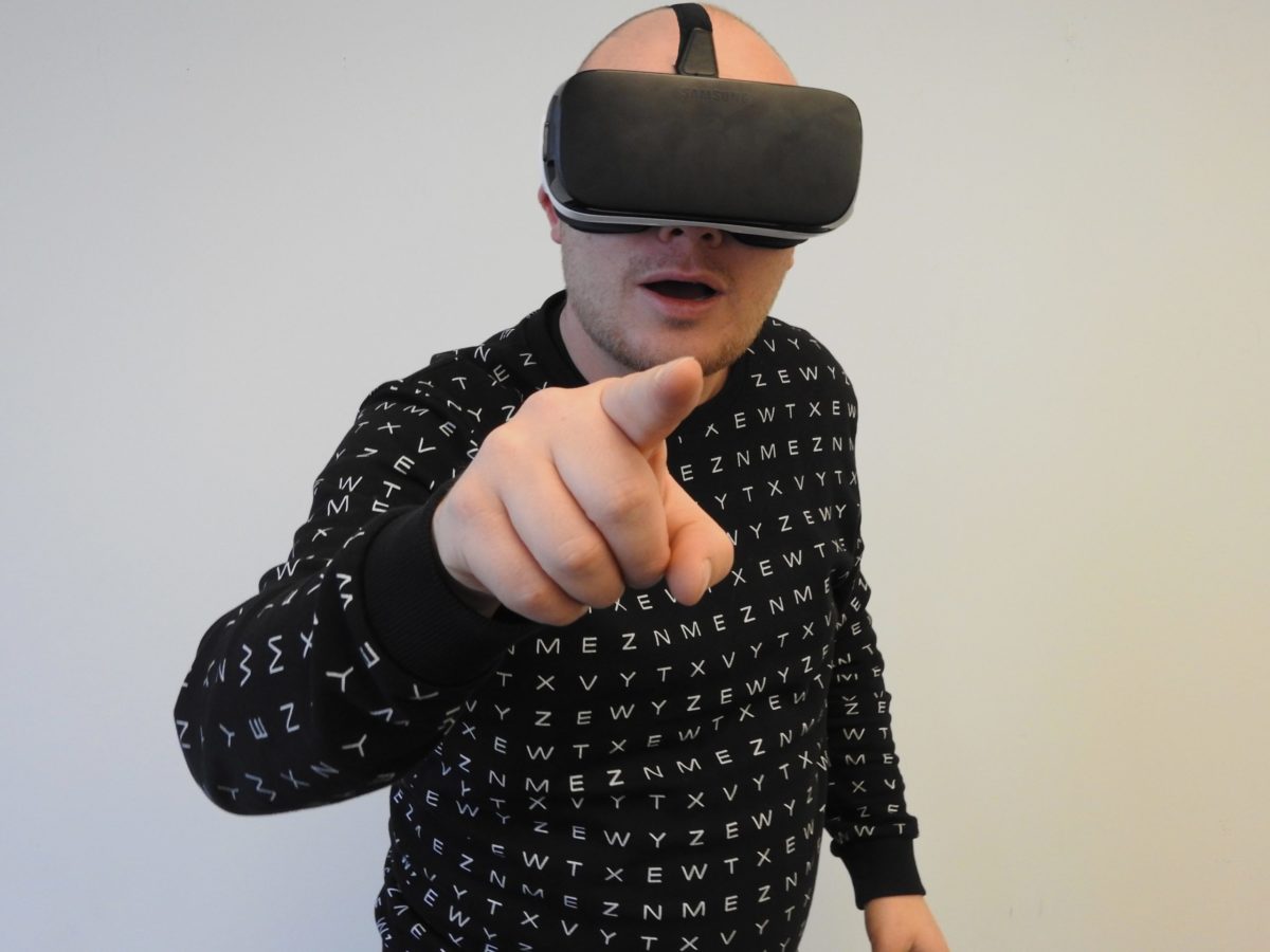 Someone using a VR headset and pointing