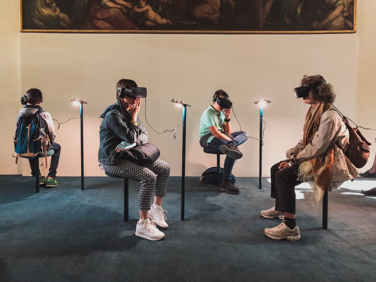 4 people using VR headsets sitting down