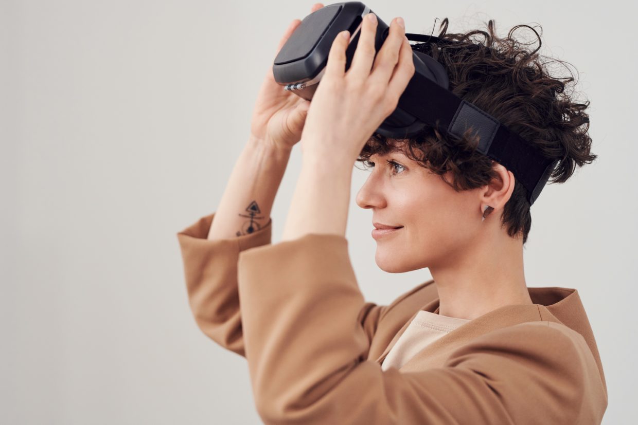 A woman putting on a VR headset