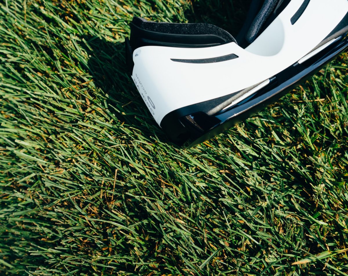 A VR headset on green grass